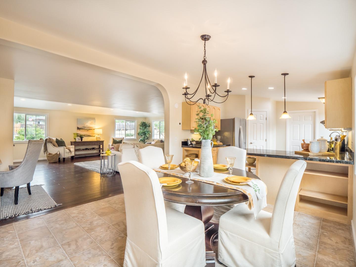 294 Hames Road Watsonville, CA 95076 - Photo 5 of 23 a view of a dining room and livingroom with furniture wooden floor kitchen view and a chandelier
