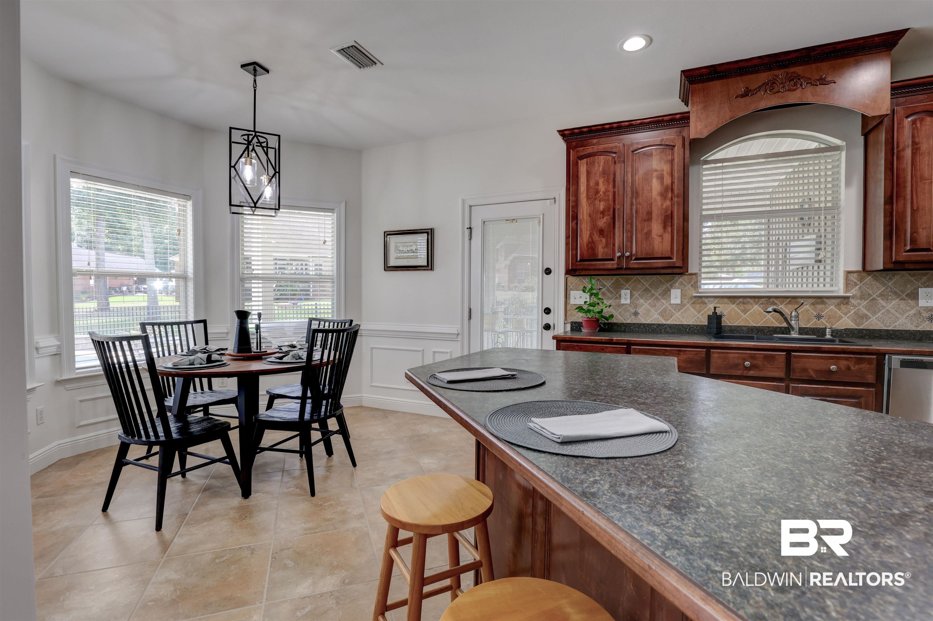 5565 Dawes Lane Theodore, AL 36582 - Photo 12 of 38 Kitchen with dishwasher, sink, light tile patterned floors, and decorative backsplash