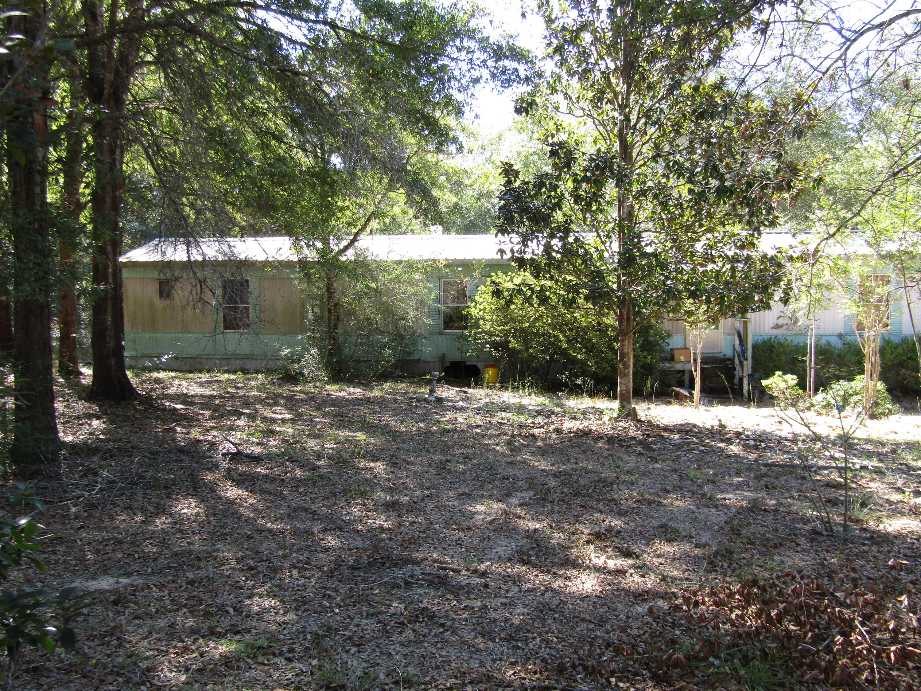 3996 Poverty Creek Road Crestview, FL 32539 - Photo 1 of 2 a view of a yard with plants and trees
