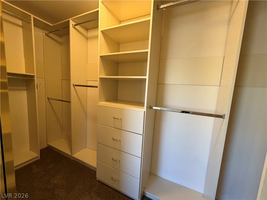 7613 Roop Street Las Vegas, NV 89131 - Photo 14 of 25 Ample storage options define this spacious closet with custom shelving and built-in drawers.