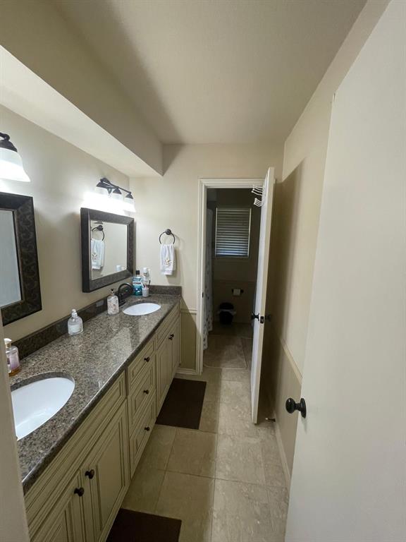 3612 Cross Bend Road Plano, TX 75023 - Photo 36 of 38 Bathroom featuring dual bowl vanity and tile flooring