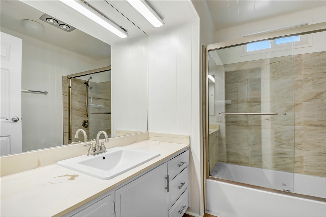 33828 Plowshare Road Wildomar, CA 92595 - Photo 11 of 22 a bathroom with a shower sink vanity and mirror