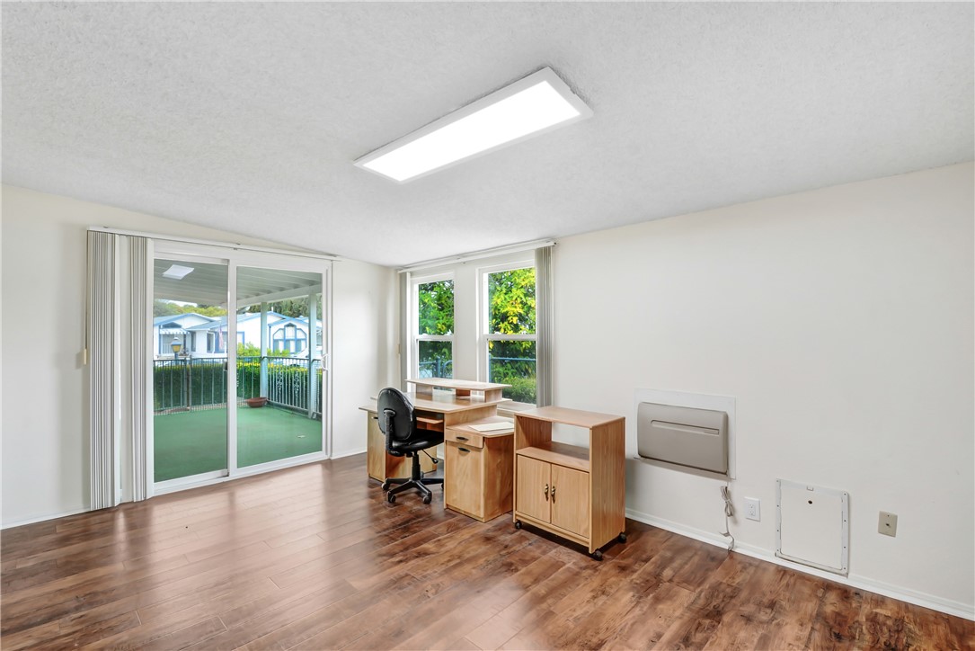 33828 Plowshare Road Wildomar, CA 92595 - Photo 14 of 22 a workspace with furniture window and wooden floor