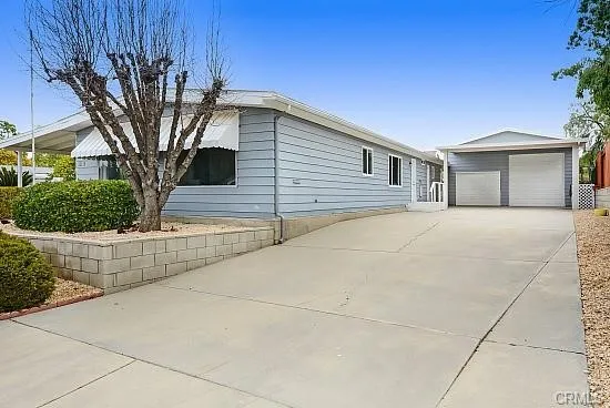 a view of a house with a large tree