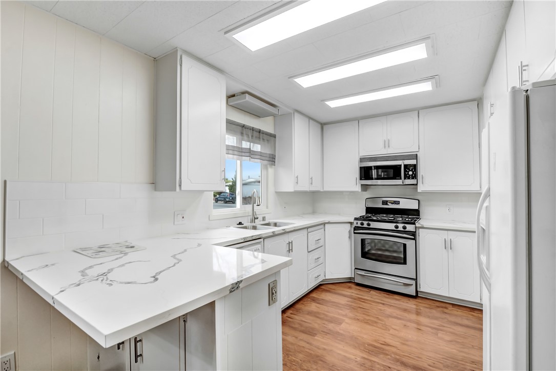 33828 Plowshare Road Wildomar, CA 92595 - Photo 6 of 22 a kitchen with stainless steel appliances granite countertop a sink stove and refrigerator