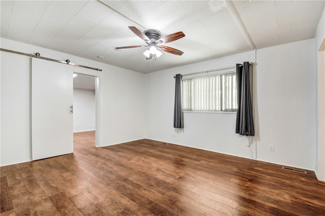 33828 Plowshare Road Wildomar, CA 92595 - Photo 7 of 22 a view of an empty room with wooden floor and a window