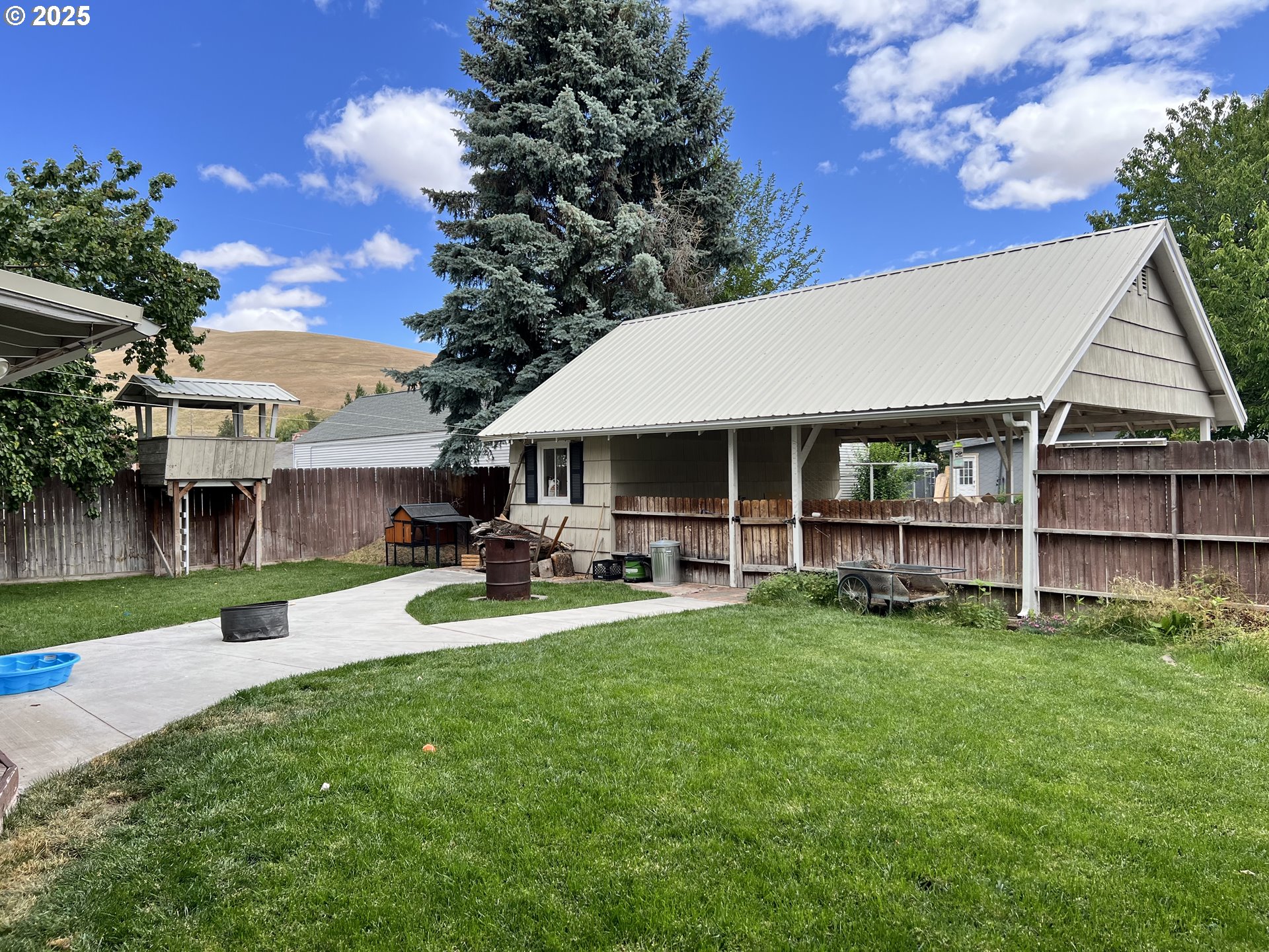 175 Baltimore Street Heppner, OR 97836 - Photo 26 of 28 a front view of a house with swimming pool and sitting area