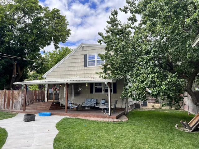 a view of a house with a yard porch and sitting area