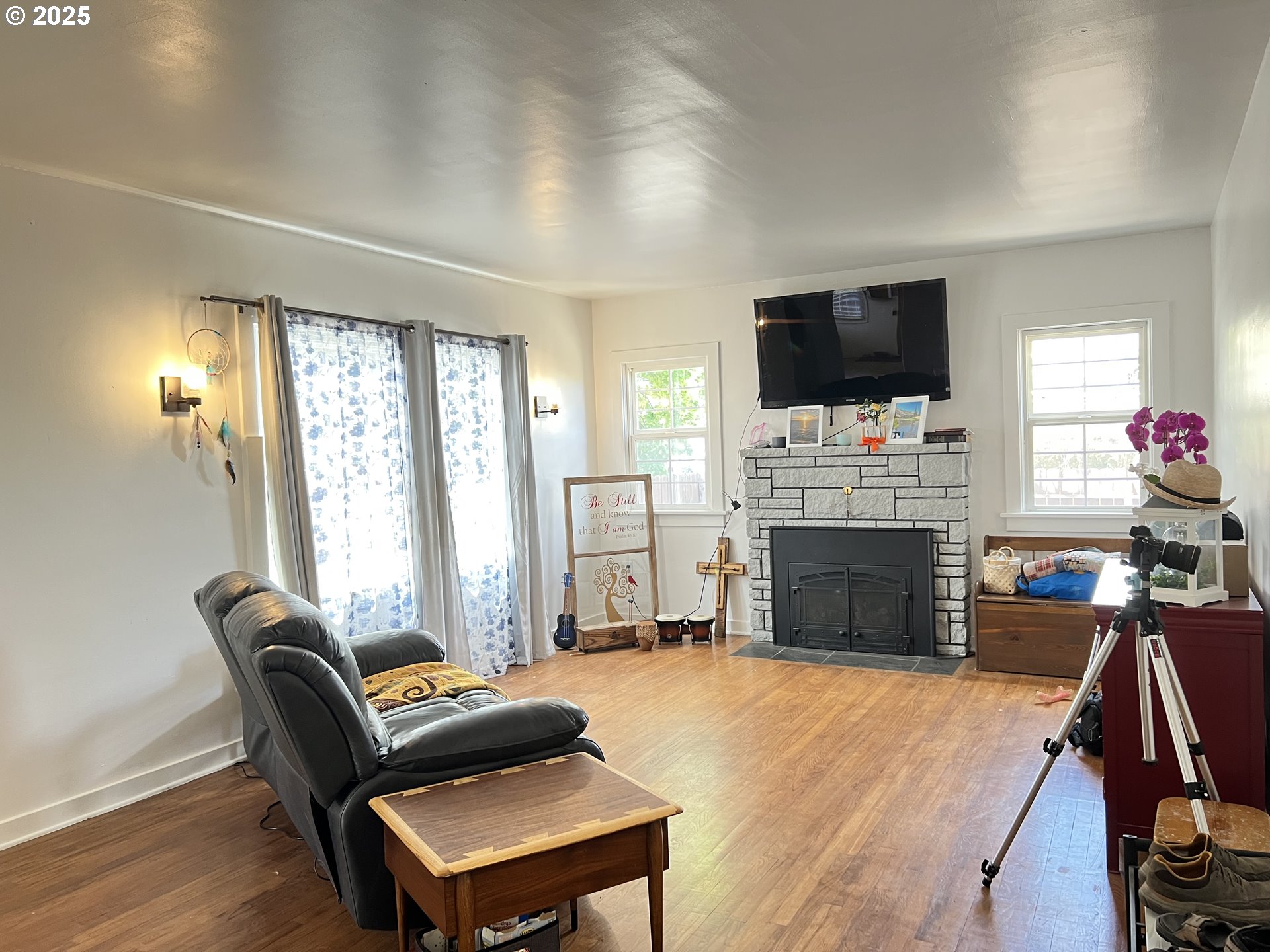 175 Baltimore Street Heppner, OR 97836 - Photo 3 of 28 a living room with furniture a flat screen tv and a fireplace