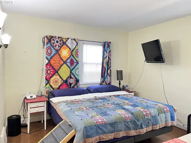 a bedroom with a bed and a flat screen tv