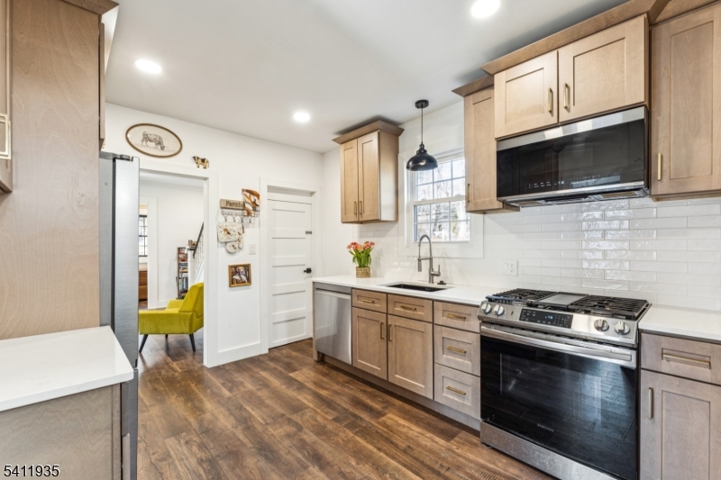 64 Hillcrest Road Watchung, NJ 07069 - Photo 15 of 42 a kitchen with stainless steel appliances a stove microwave and sink