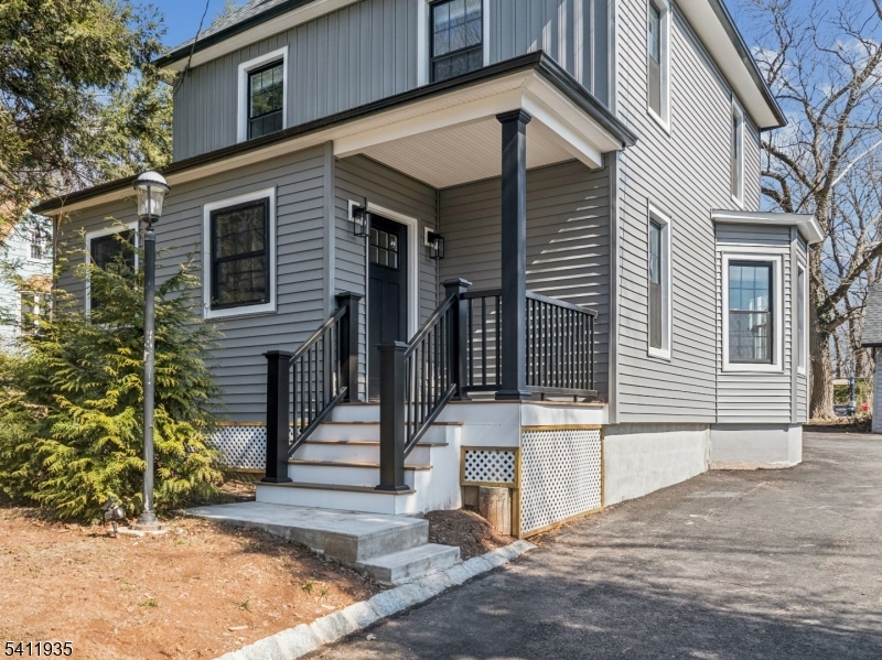 64 Hillcrest Road Watchung, NJ 07069 - Photo 2 of 42 a front view of a house with a tree