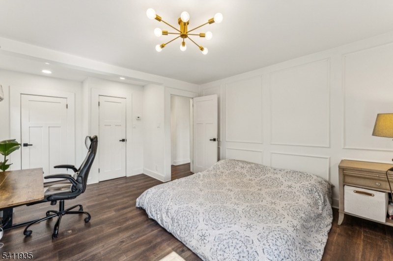 64 Hillcrest Road Watchung, NJ 07069 - Photo 26 of 42 a bedroom with a bed a desk and chair with wooden floor