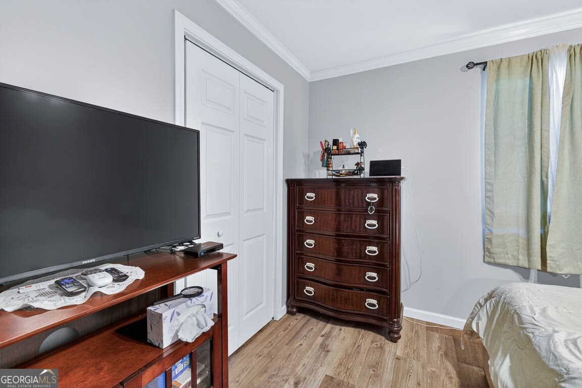 33 Warren Avenue Waverly, GA 31565 - Photo 10 of 63 a bedroom with a bed and a tv in it