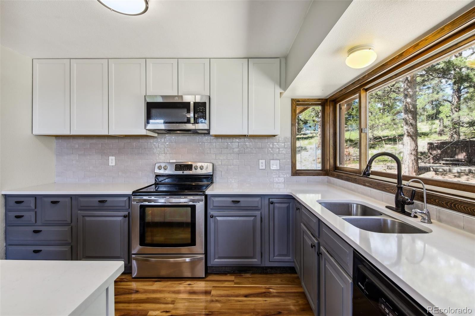 141 Tall Timber Lane Bailey, CO 80421 - Photo 16 of 40 a kitchen with stainless steel appliances granite countertop a sink and a stove