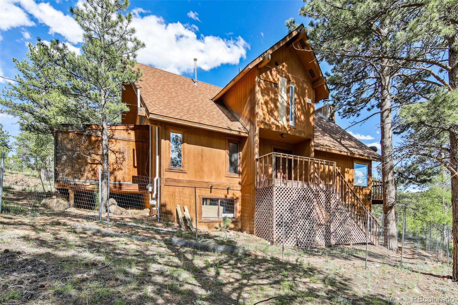 141 Tall Timber Lane Bailey, CO 80421 - Photo 2 of 40 a view of a house with a large tree