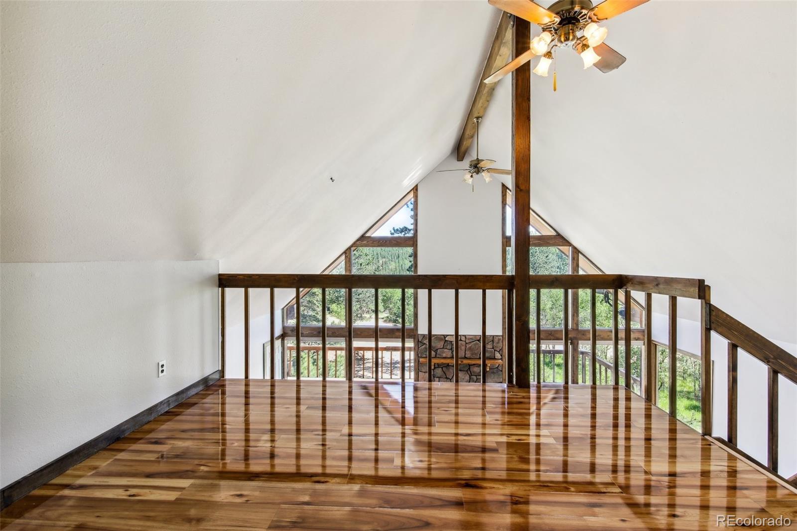 141 Tall Timber Lane Bailey, CO 80421 - Photo 22 of 40 a view of staircase with railing and white walls