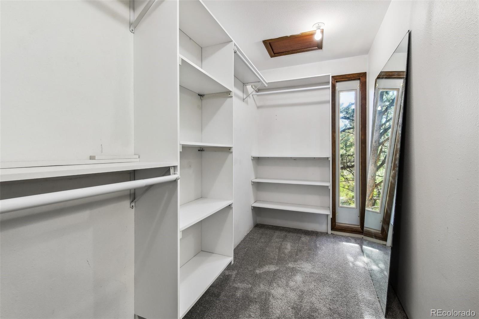 141 Tall Timber Lane Bailey, CO 80421 - Photo 23 of 40 a view of walk in closet with empty racks
