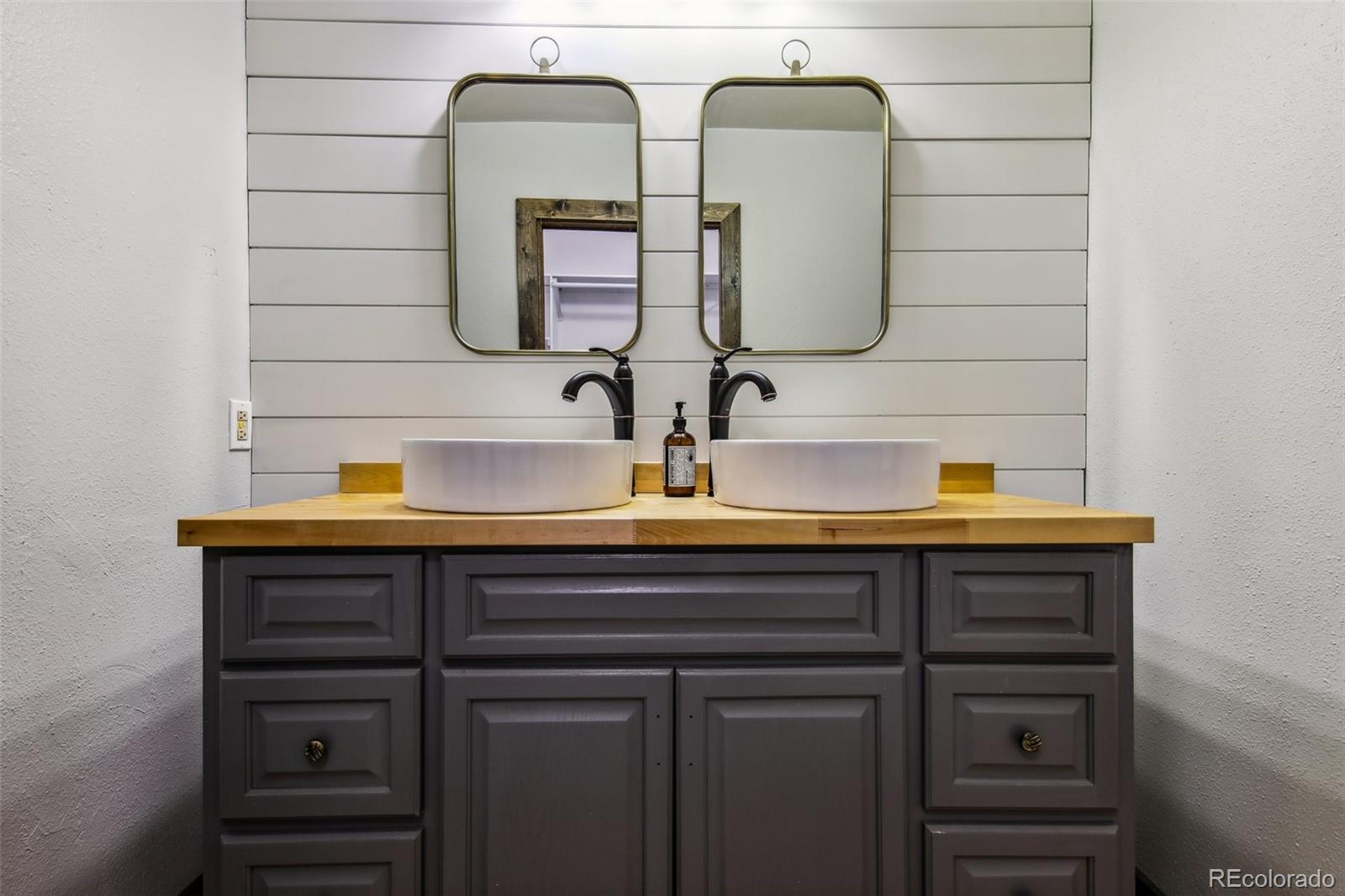 141 Tall Timber Lane Bailey, CO 80421 - Photo 25 of 40 a bathroom with a double vanity sink and two mirror