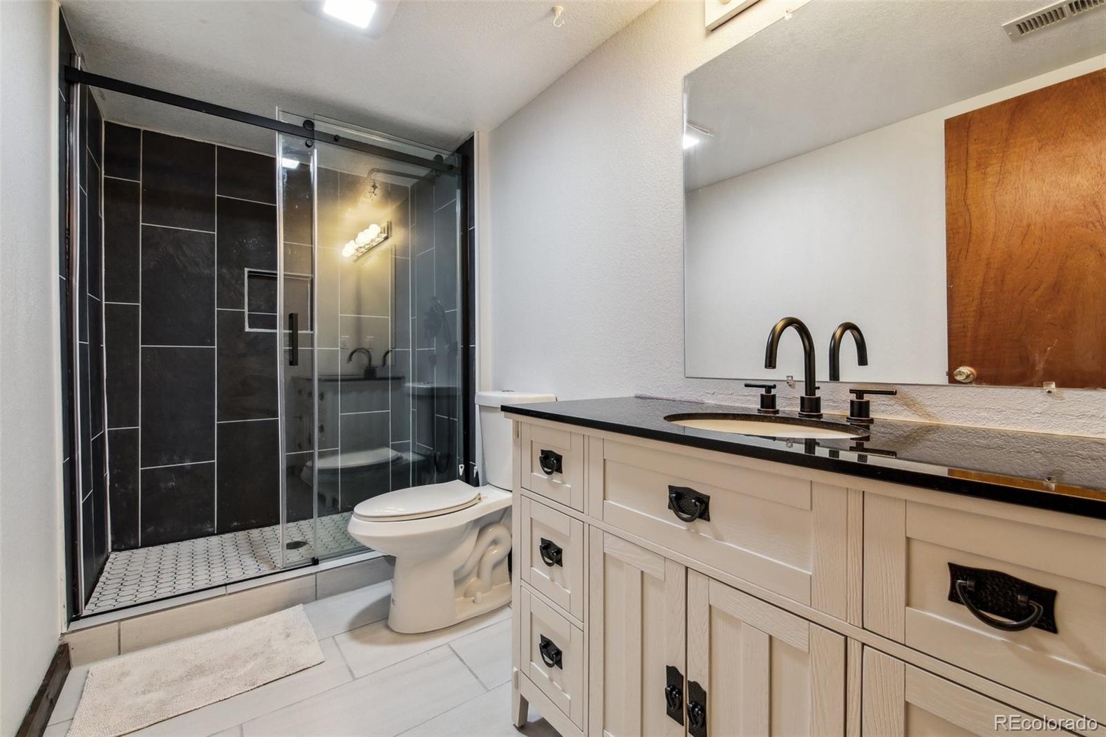 141 Tall Timber Lane Bailey, CO 80421 - Photo 32 of 40 a bathroom with a sink toilet and shower