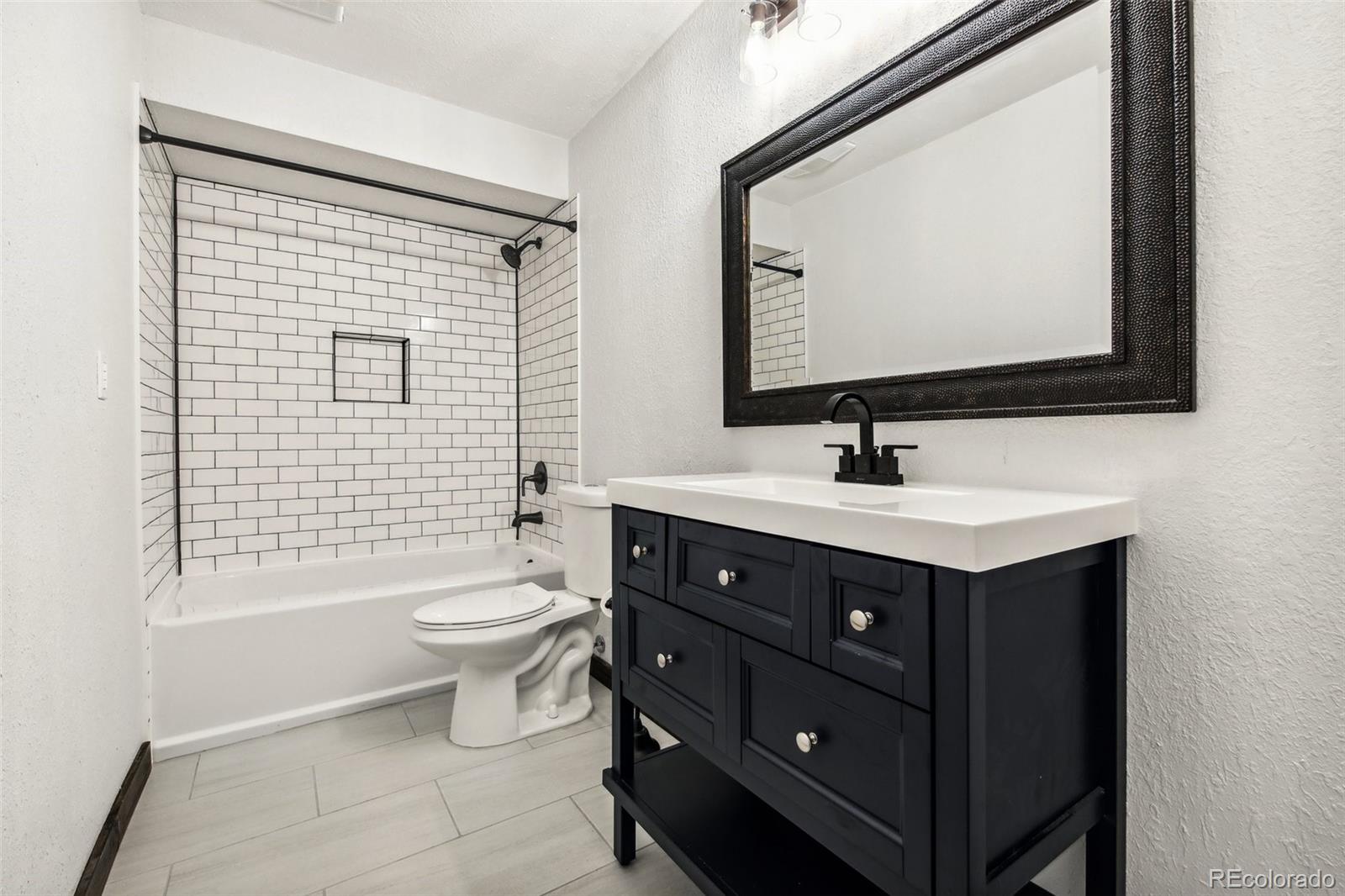 141 Tall Timber Lane Bailey, CO 80421 - Photo 38 of 40 a bathroom with a sink vanity mirror and toilet