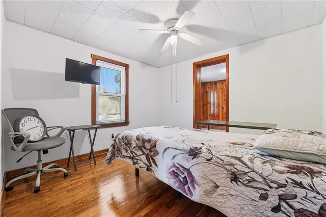 a bedroom with a bed window and chair