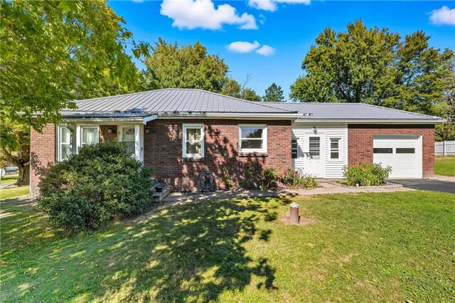 a front view of a house with a garden