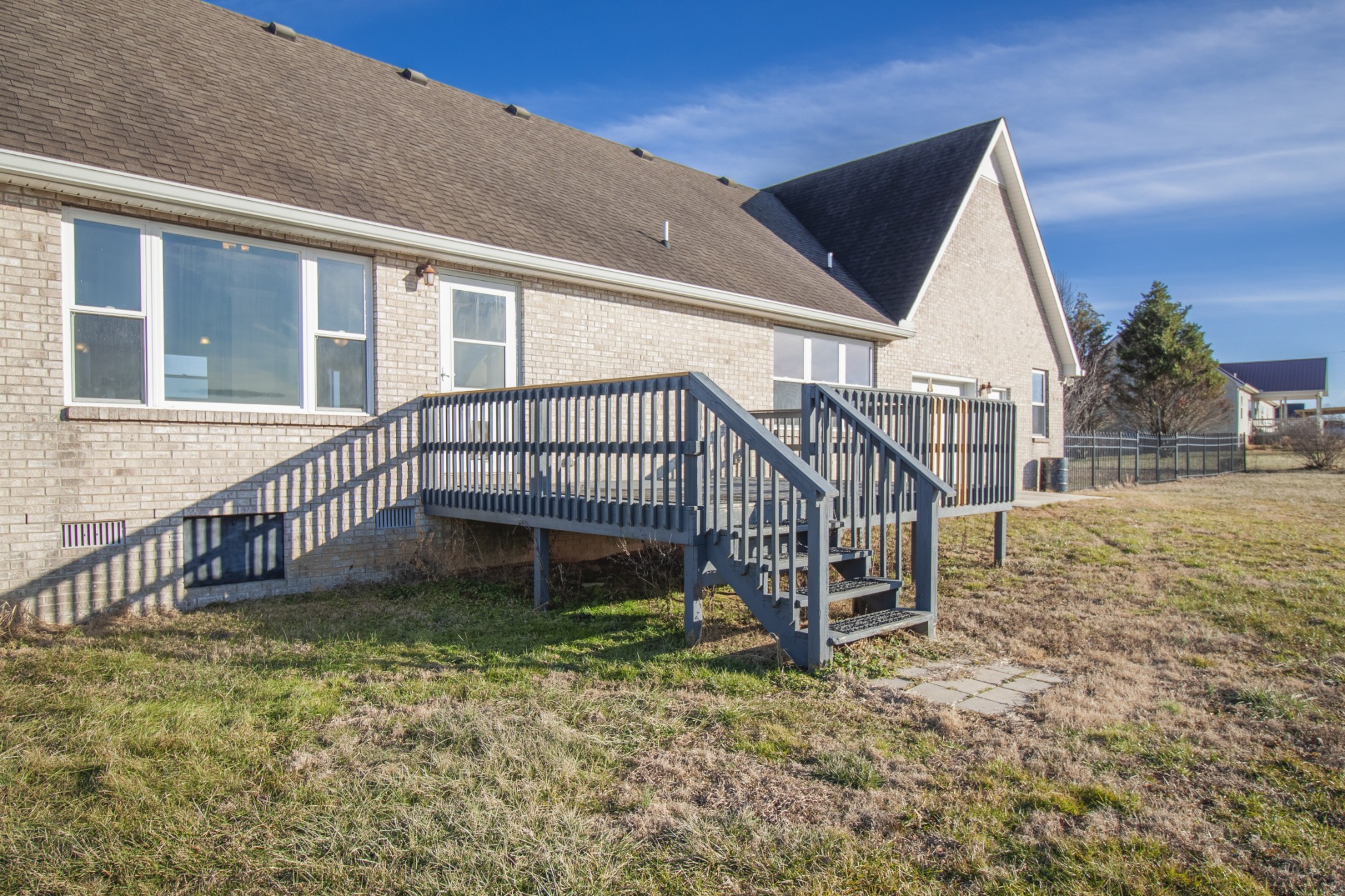 6875 Maple Springs Road Manchester, TN 37355 - Photo 20 of 36 a view of a house with a yard and a wooden deck