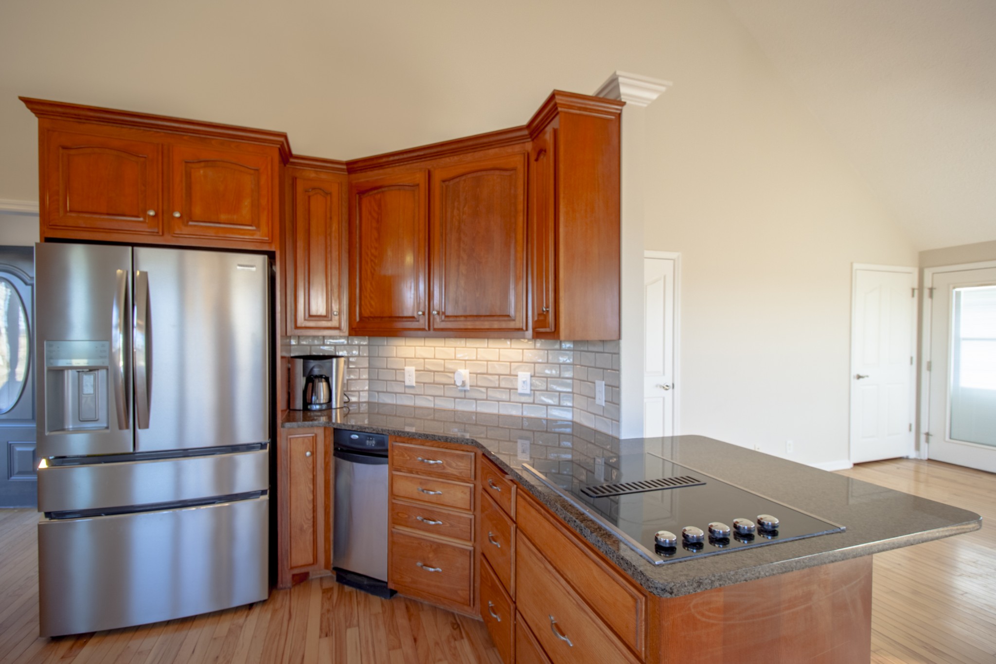 6875 Maple Springs Road Manchester, TN 37355 - Photo 26 of 36 a kitchen with stainless steel appliances granite countertop a refrigerator a sink dishwasher a stove with wooden cabinets