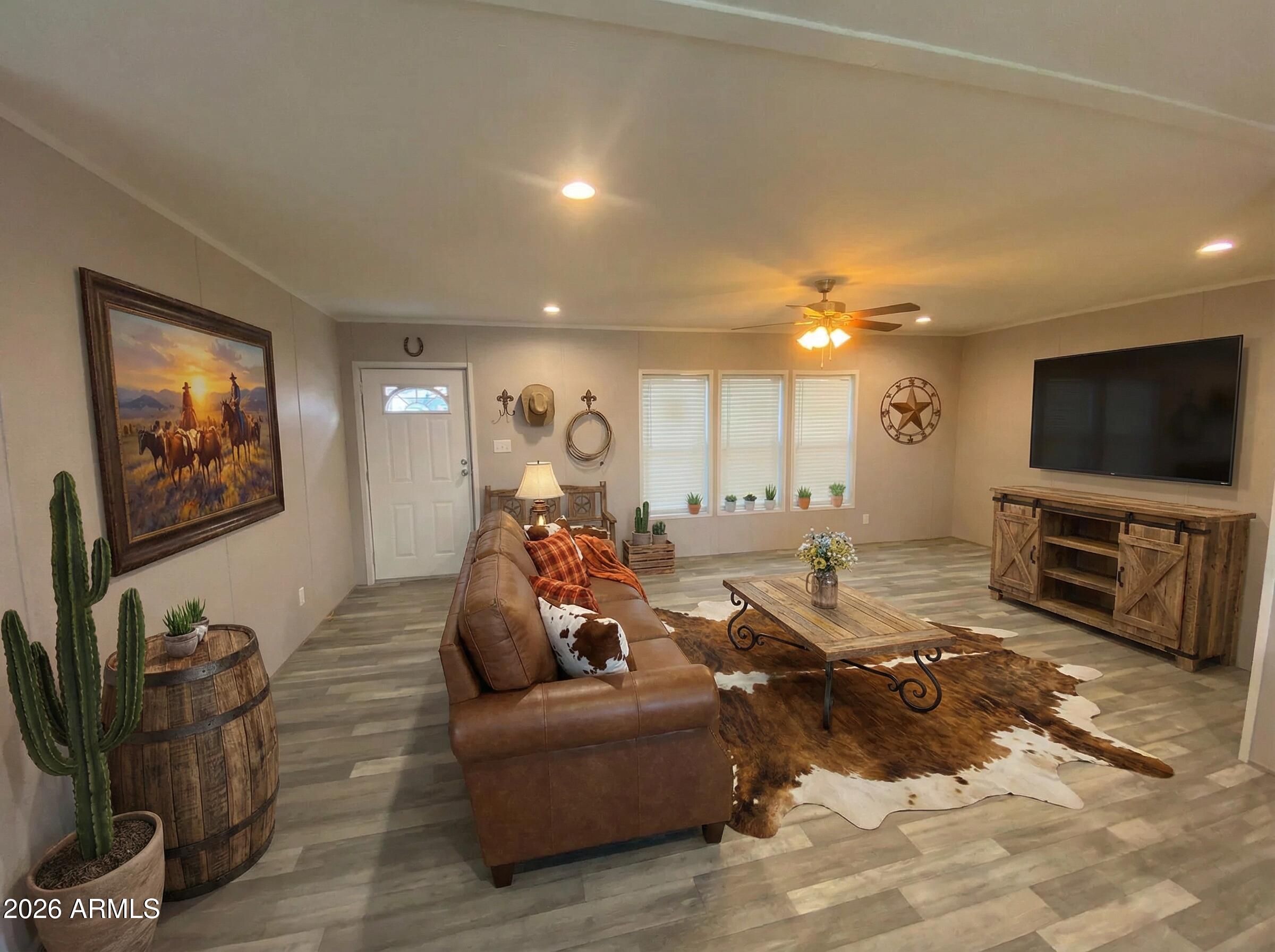 519 South Ortega Road Stanfield, AZ 85172 - Photo 12 of 27 a living room with furniture and a flat screen tv