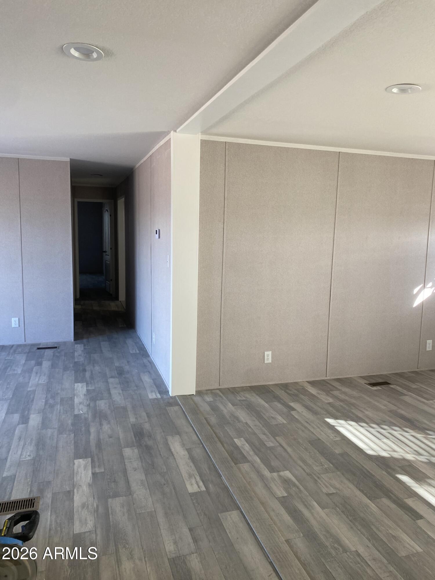 519 South Ortega Road Stanfield, AZ 85172 - Photo 17 of 29 a view of an empty room with wooden floor