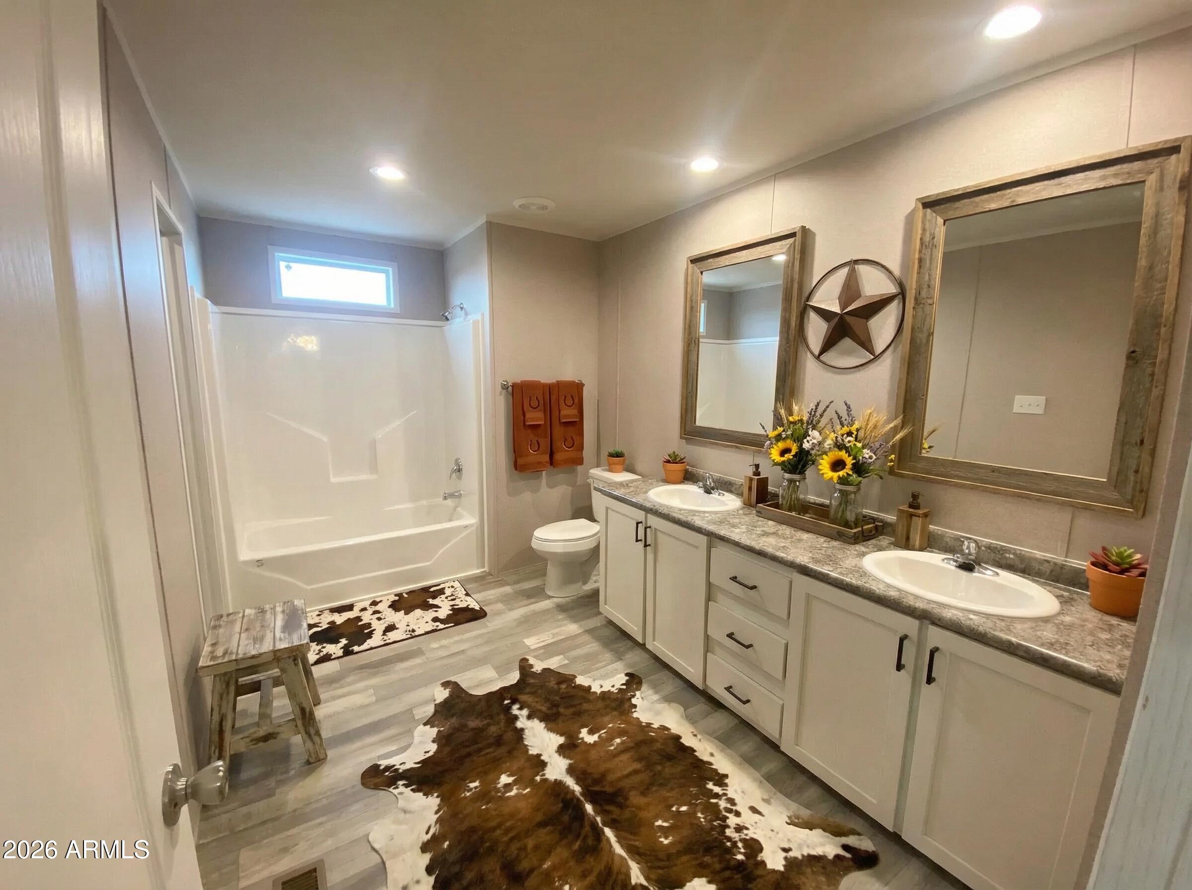 519 South Ortega Road Stanfield, AZ 85172 - Photo 18 of 27 a bathroom with a sink and a mirror