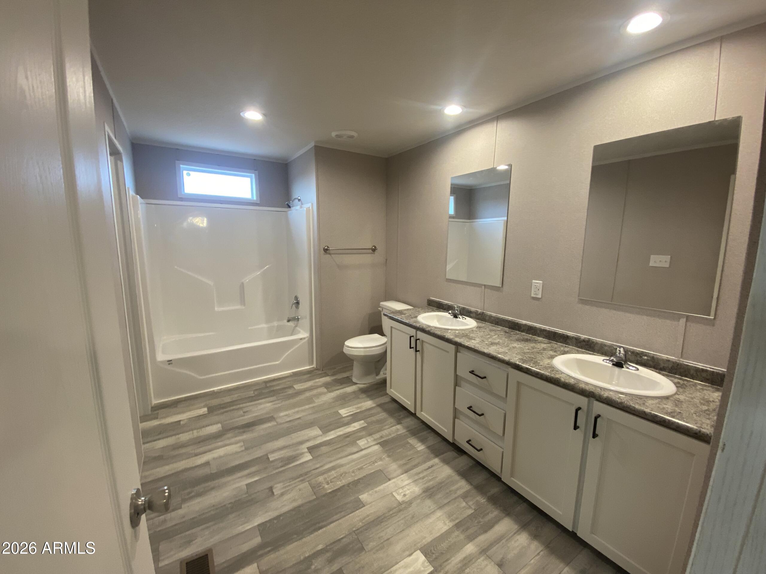 519 South Ortega Road Stanfield, AZ 85172 - Photo 21 of 29 a bathroom with a double vanity sink and a mirror