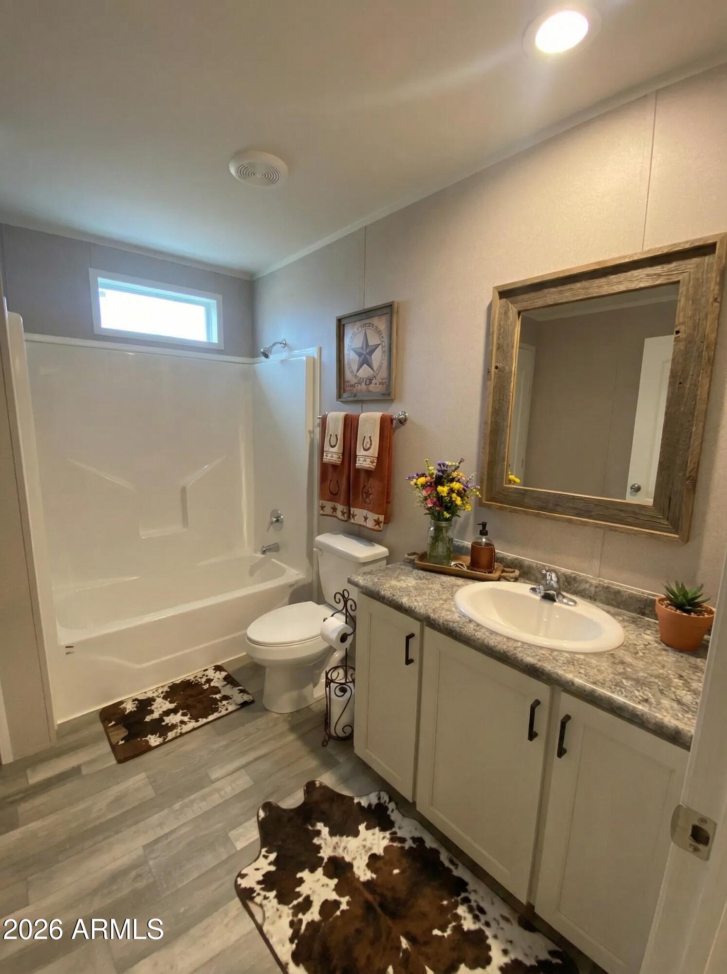 519 South Ortega Road Stanfield, AZ 85172 - Photo 24 of 27 a bathroom with a toilet a sink and mirror