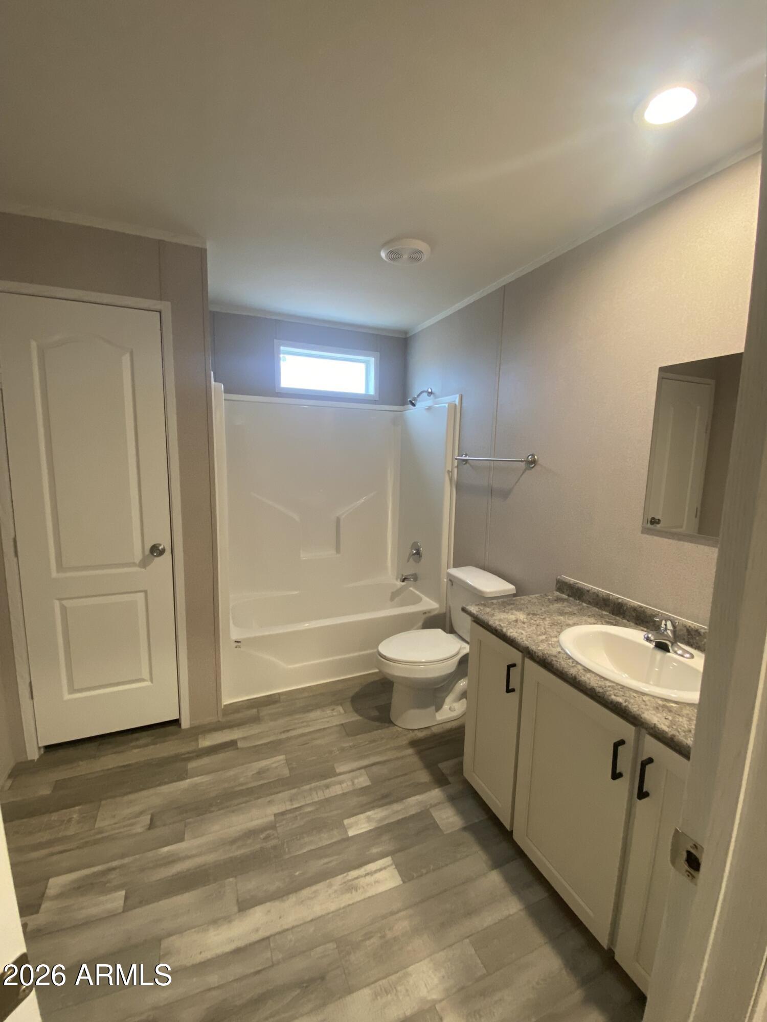519 South Ortega Road Stanfield, AZ 85172 - Photo 27 of 29 a bathroom with a toilet sink and mirror