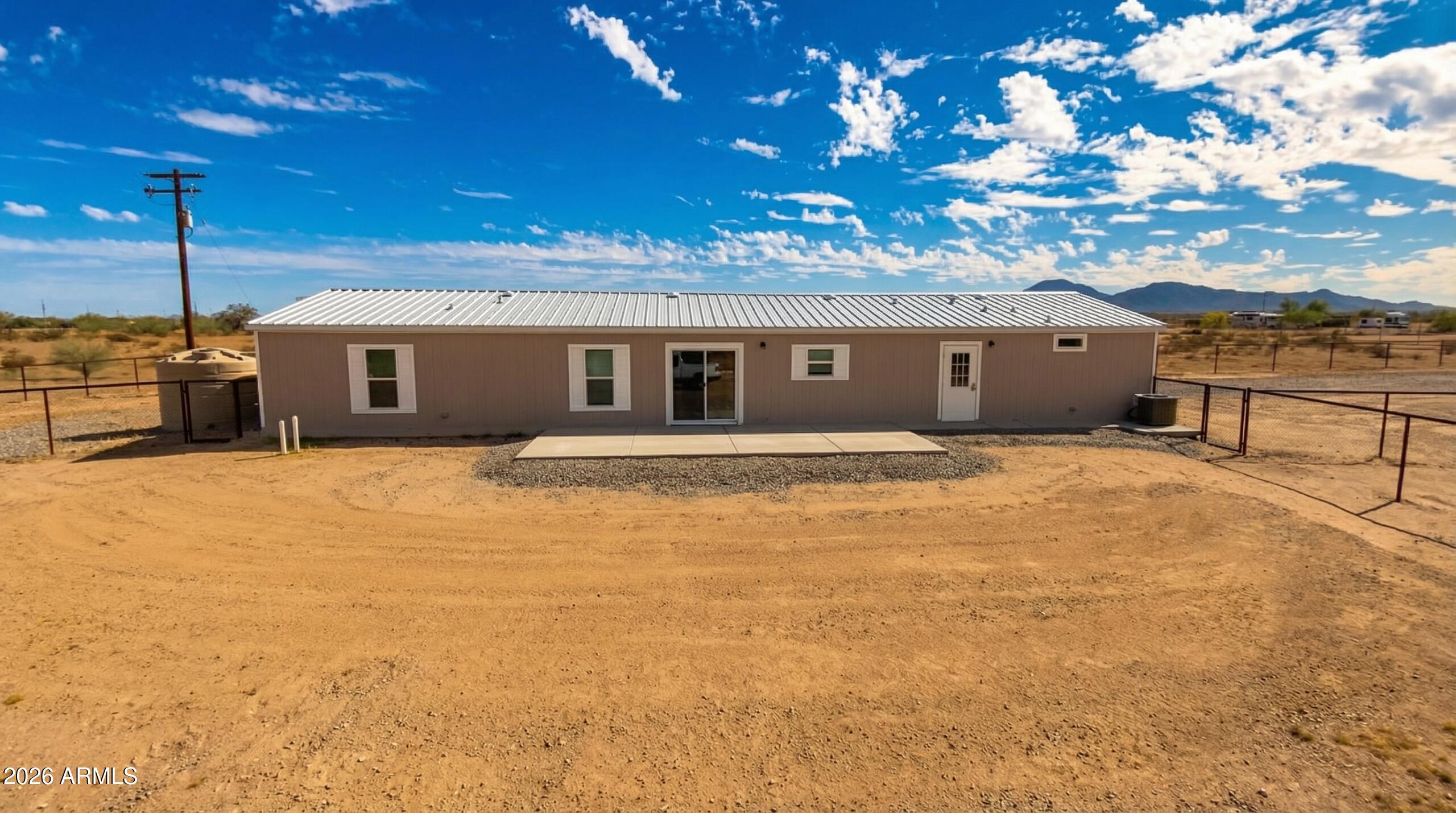 519 South Ortega Road Stanfield, AZ 85172 - Photo 2 of 27 a front view of a house with a big yard