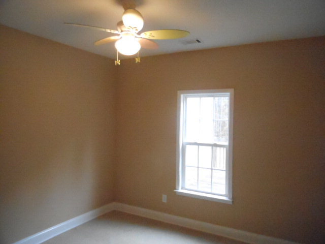 661 Altman Road Gray, GA 31032 - Photo 8 of 9 an empty room with a window and a fan
