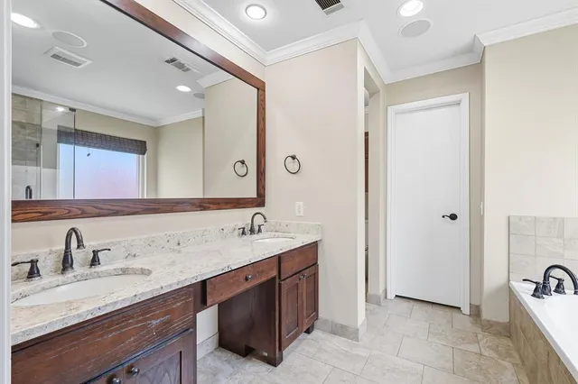a bathroom with a sink double vanity and a mirror
