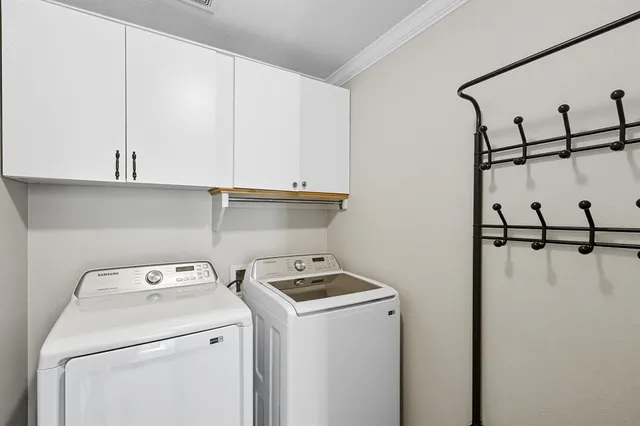 a view of storage and utility room with washer and dryer