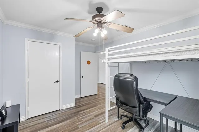 a view of a workspace with furniture and a chandelier fan
