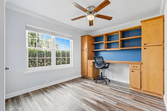 a view of a workspace with furniture and a window