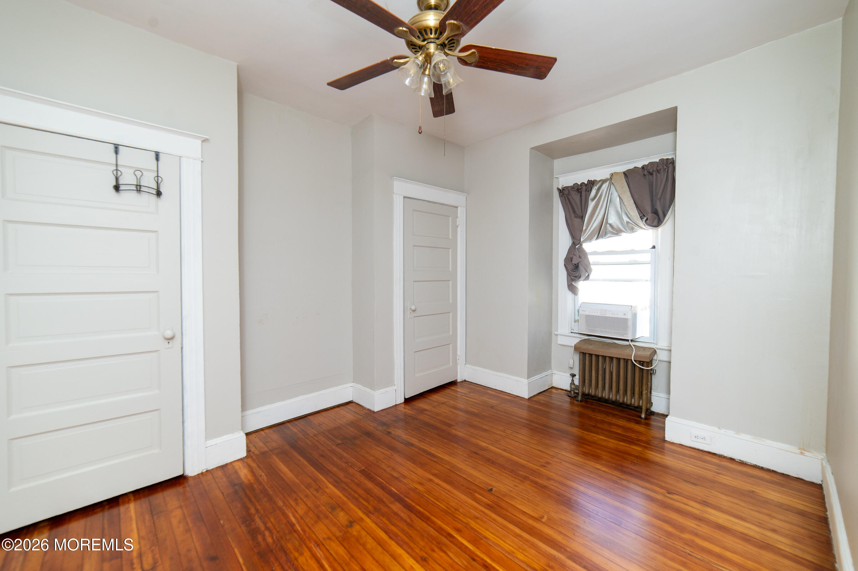 38 Walnut Street Keyport, NJ 07735 - Photo 17 of 19 a view of empty room with wooden floor and fan