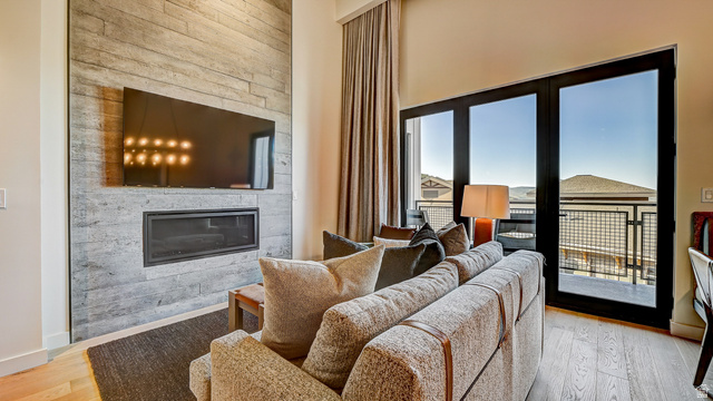 2417 West High Road, Unit 2515 Park City, UT 84098 - Photo 2 of 67 Living area featuring a fireplace and light wood-style flooring