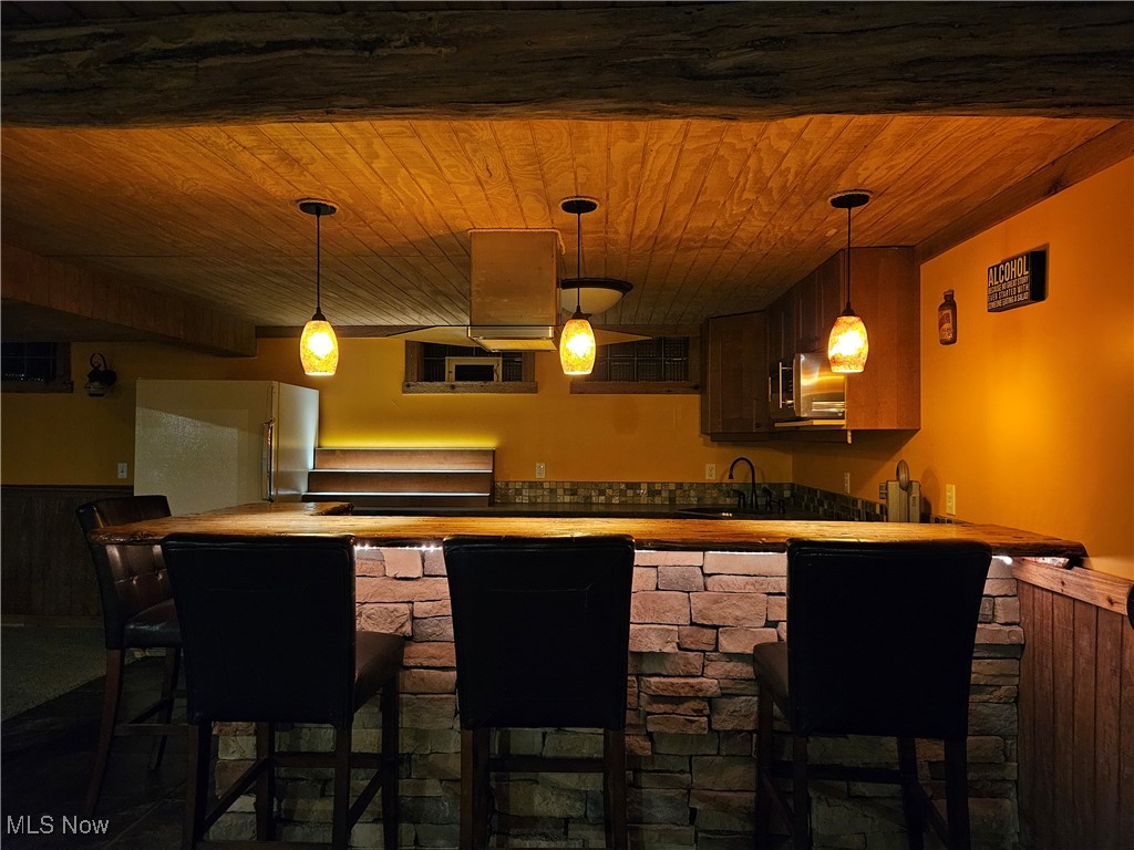 6155 Beach Road Wadsworth, OH 44281 - Photo 31 of 49 View of basement bar and kitchen featuring wood ceiling and adjustable lighting