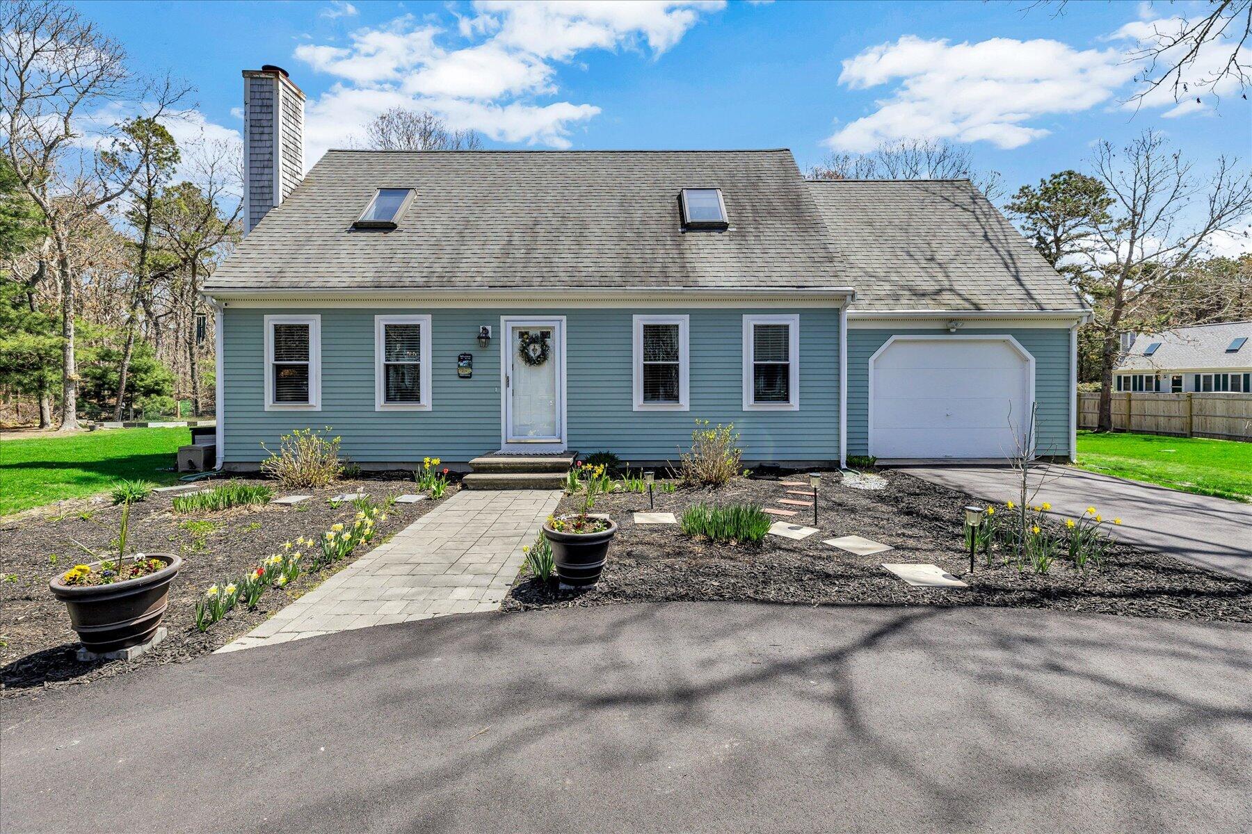 12 Drew Lane Mashpee, MA 02649 - Photo 1 of 49 a front view of a house with garden