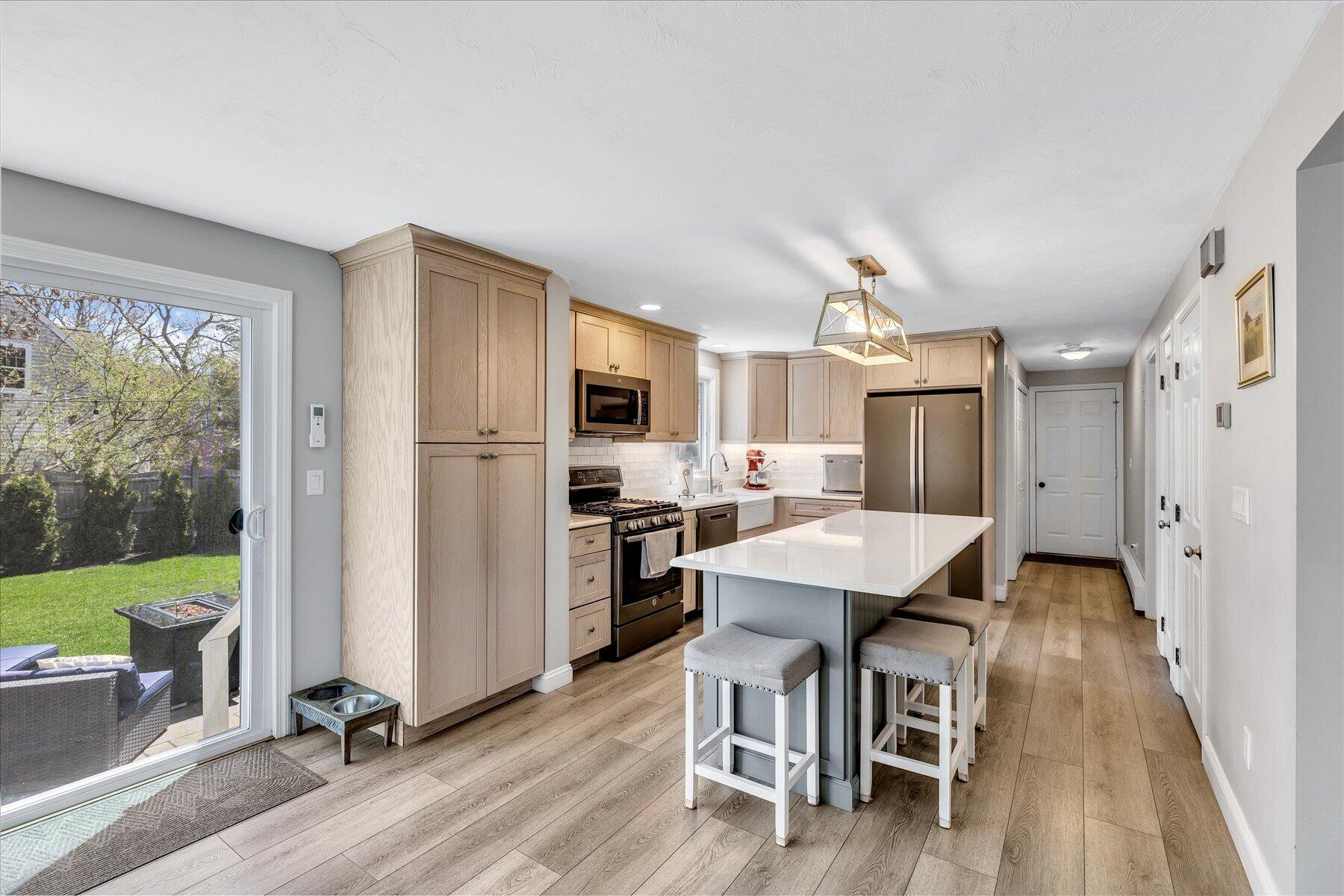 12 Drew Lane Mashpee, MA 02649 - Photo 15 of 49 a view of kitchen with stainless steel appliances refrigerator stove dining table and chairs