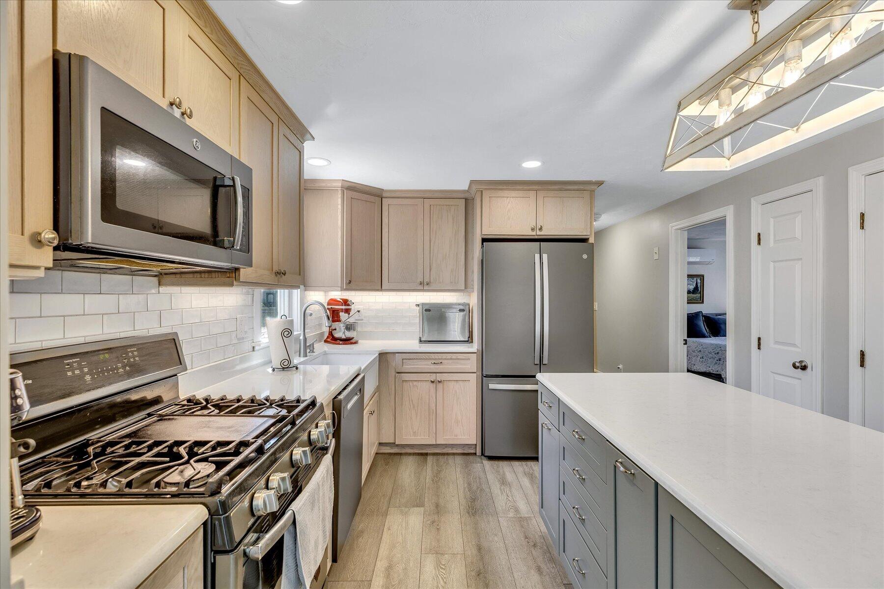 12 Drew Lane Mashpee, MA 02649 - Photo 16 of 49 a kitchen with a stove a sink and a microwave