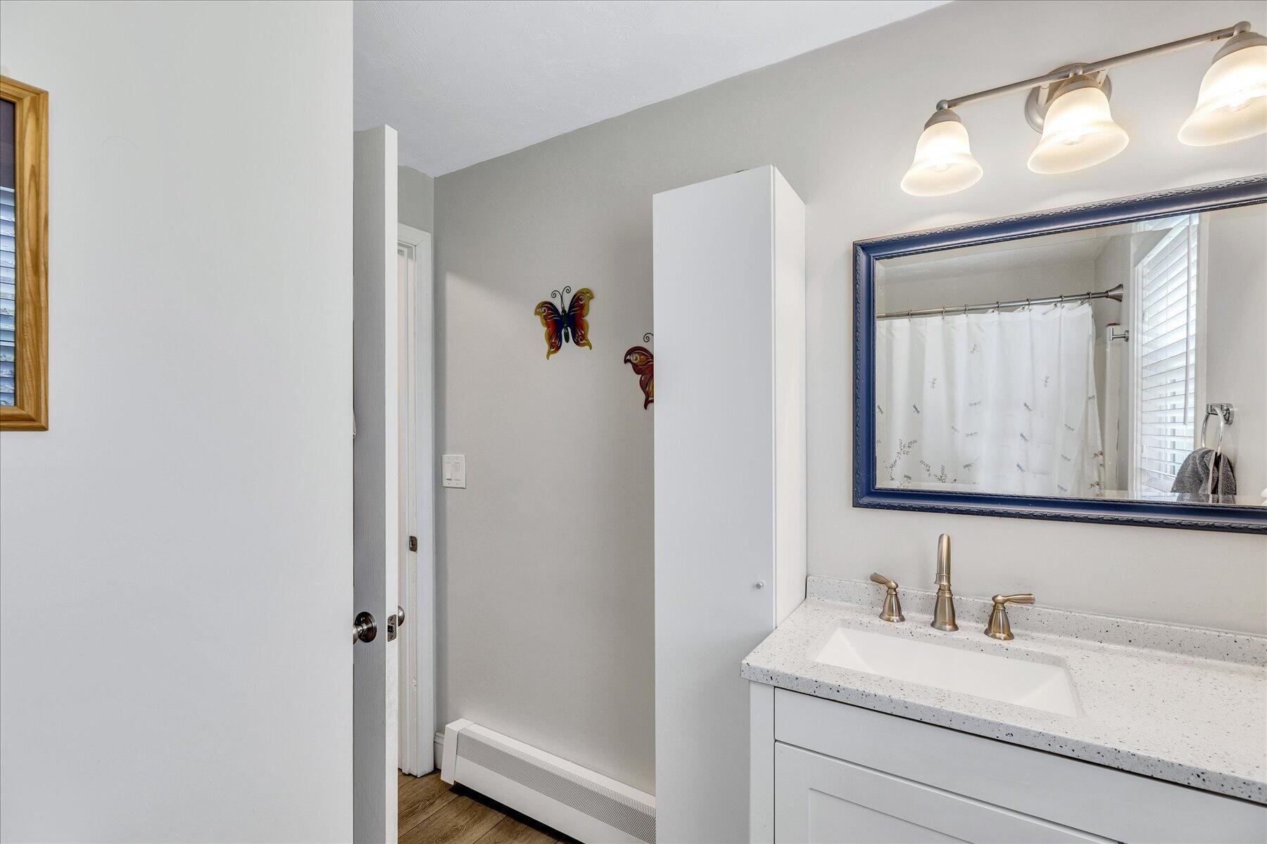 12 Drew Lane Mashpee, MA 02649 - Photo 24 of 49 a bathroom with a sink and a mirror