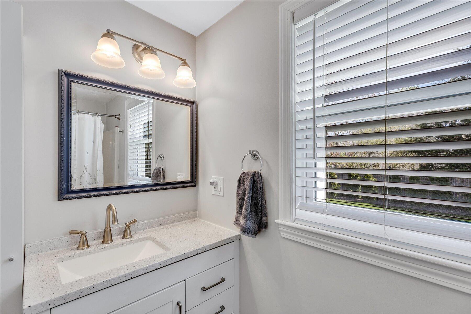 12 Drew Lane Mashpee, MA 02649 - Photo 26 of 49 a bathroom with a sink a mirror and a window