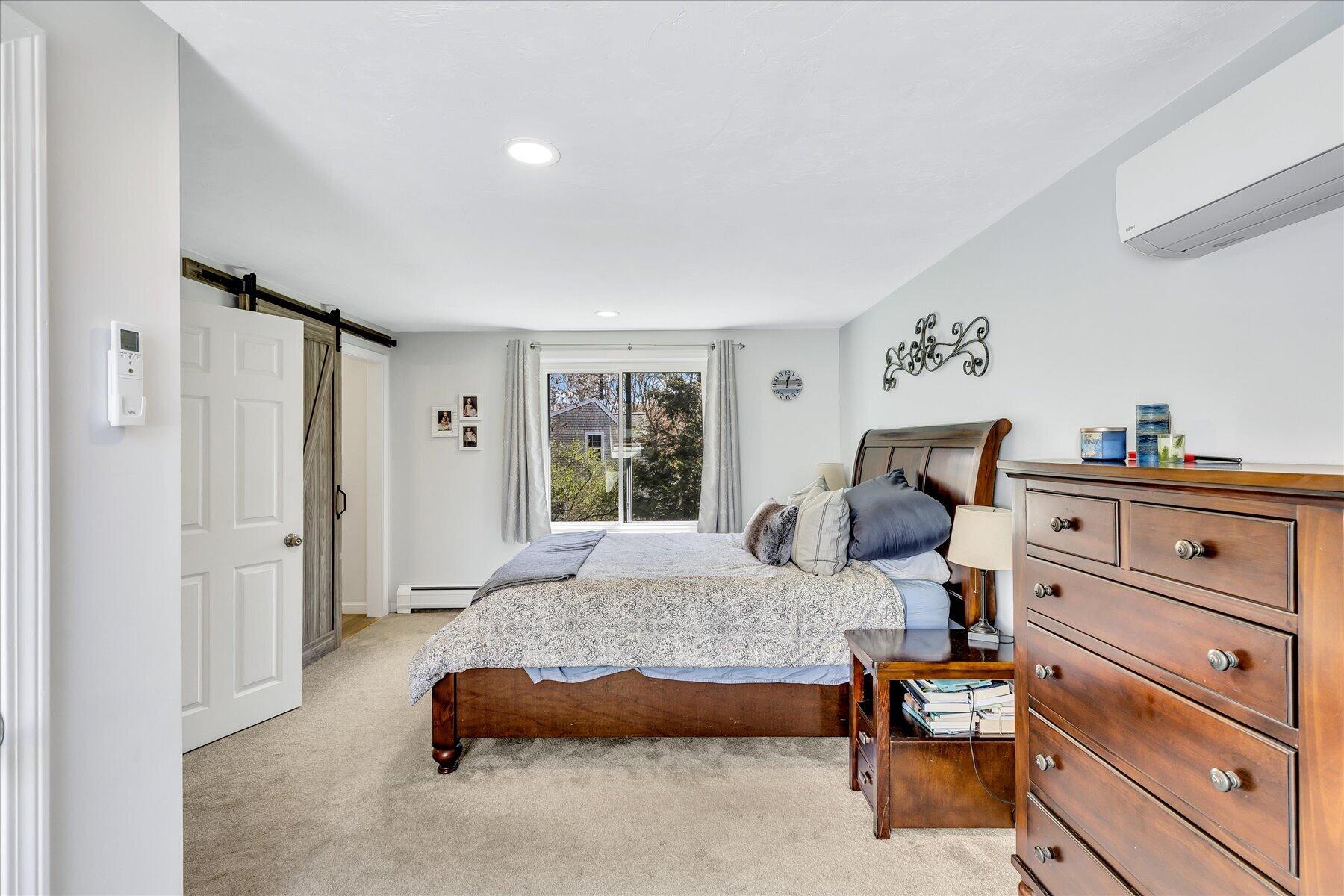 12 Drew Lane Mashpee, MA 02649 - Photo 28 of 49 a bedroom with a bed and wooden floor